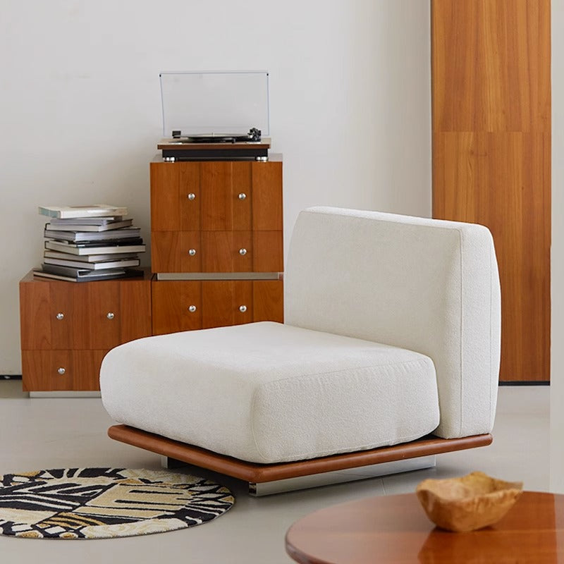 Modern white Nozomi Banca Sofa in stylish living room setting with wooden furniture and turntable.