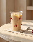 Tall Cherry Glass with iced coffee on a round table