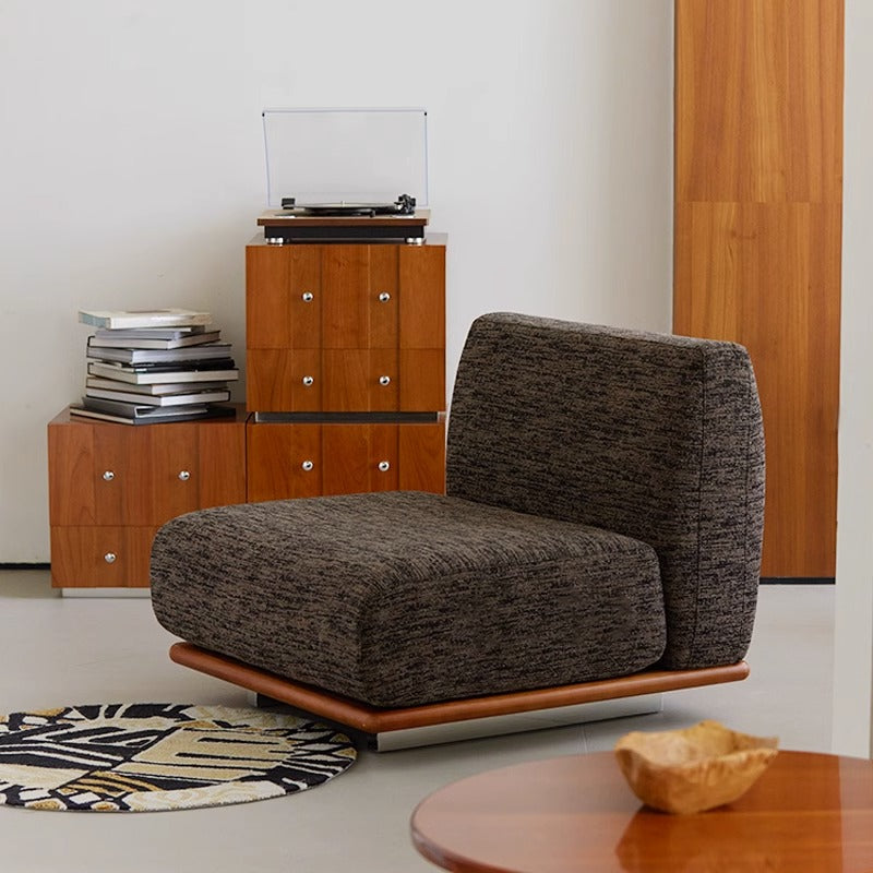 Modern Nozomi Banca Sofa with gray upholstery in a stylish living room setting featuring wooden cabinets and a turntable.