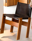 Modern leather-seat dining chair with solid wood frame, shown in black, part of the Nosaku Monk Chair collection.