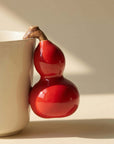 Close detail of the fruit-inspired ceramic handle