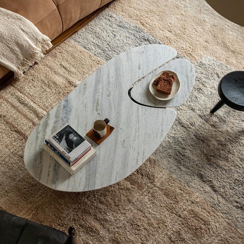 Modern Wabi-Sabi coffee table with natural wood and stone tabletop, featuring a smooth curved design in a cozy living area.