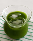 Sora Glass filled with matcha on a green striped cloth