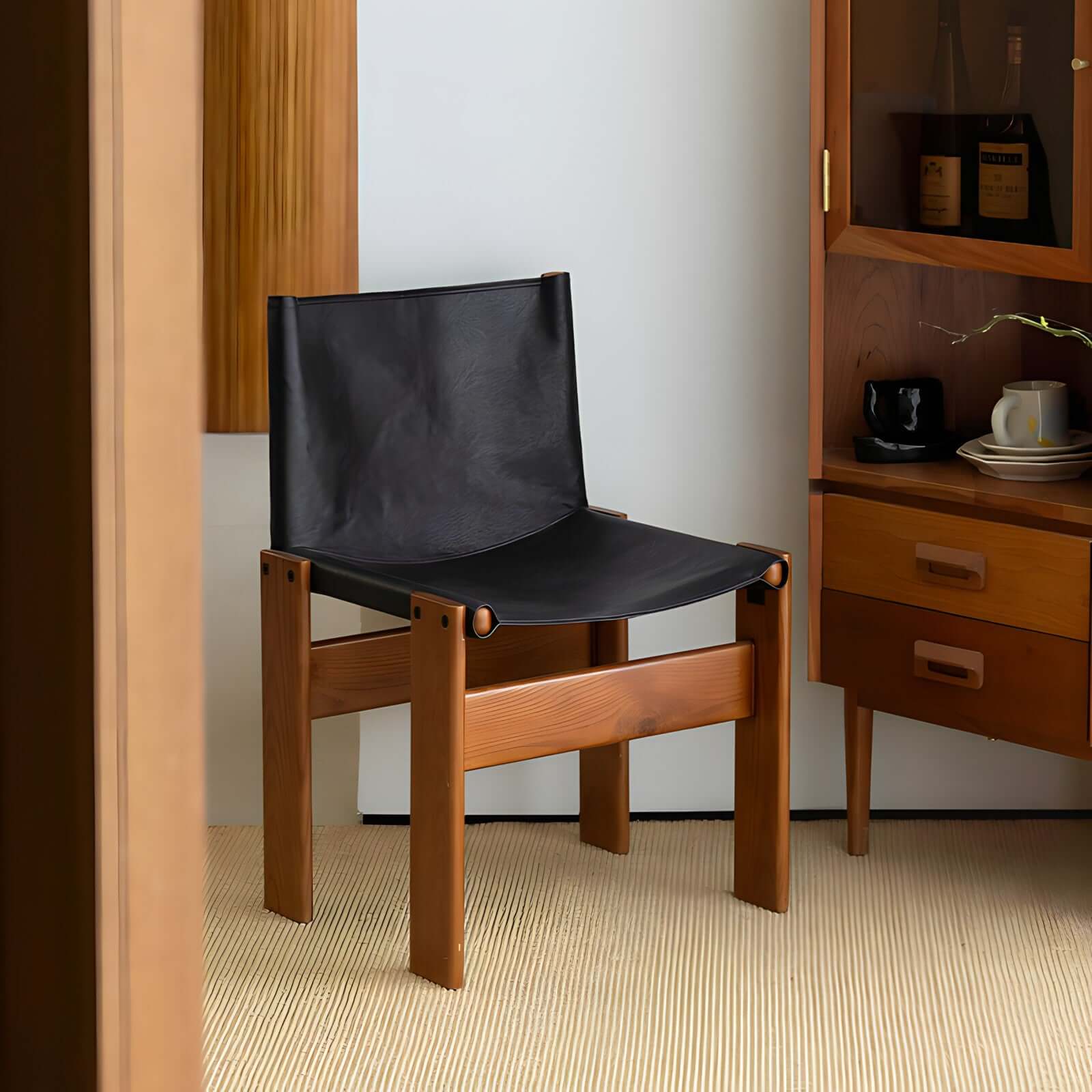 Black leather seat dining chair with solid wood frame in a modern dining room setting.