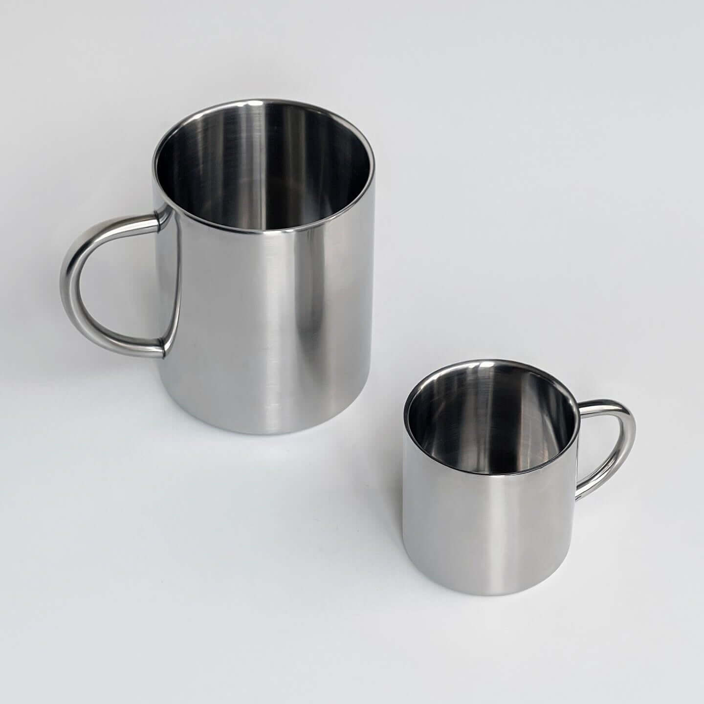 Two double-layer glossy stainless steel cups in different sizes on a white background.