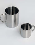 Two double-layer glossy stainless steel cups in different sizes on a white background.