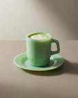 Mint Green Pastel Muse Mug with matcha on its saucer