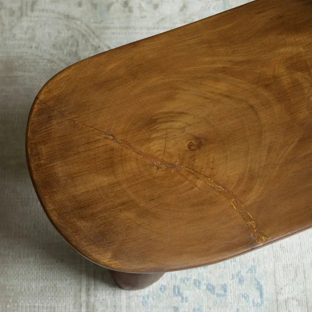 Close-up of an African Senufo wood milk stool showing natural tree textures and unique handcrafted design.