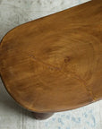 Close-up of an African Senufo wood milk stool showing natural tree textures and unique handcrafted design.
