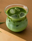 Sora Glass with iced matcha on a wooden table