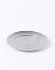 Stainless steel vintage round plate with a chic design, ideal for versatile use, shown on a plain background.
