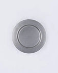Stainless steel vintage round plate with minimalist design, durable and versatile for various uses.