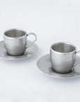 Vintage Inox stainless steel cup and saucer set from Japan, dishwasher safe, shown on a white background.