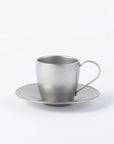 Stainless steel vintage cup and saucer set, featuring a sleek silver finish, made in Japan, perfect for elegant tea or coffee serving.