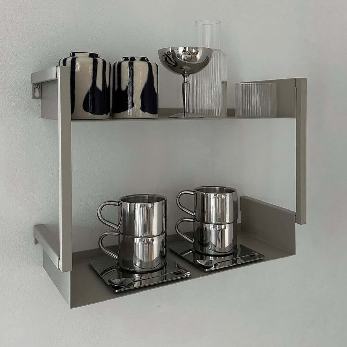Sleek Venice Mirror Cup Set with saucers showcased on minimalist shelf with modern glassware.