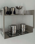 Sleek Venice Mirror Cup Set with saucers showcased on minimalist shelf with modern glassware.