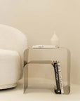 Minimalist stainless steel bedside table with books and decor, contemporary design, ideal for modern home interiors.