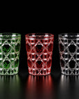 Green, red and black Vetra Lattice hand-painted glasses side by side on a black background