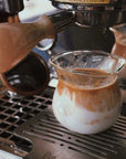 Sora Glass under an espresso machine filling with coffee