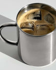 Double-layer glossy stainless steel cup with iced coffee, showcasing modern elegance and temperature control features.