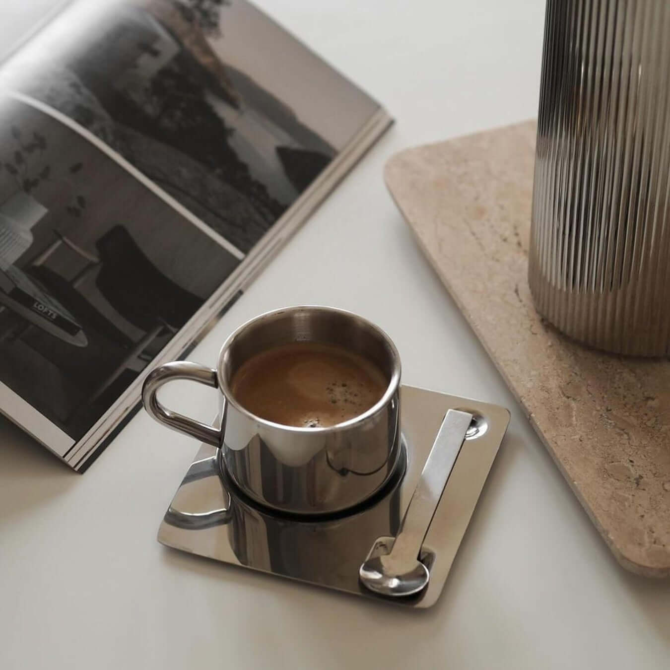 Venice Mirror Cup Set with saucer and spoon on table, showcasing polished mirror finish and modern elegance.