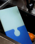 Blue Cheese Puzzle Pop Chopping Board standing in a sink