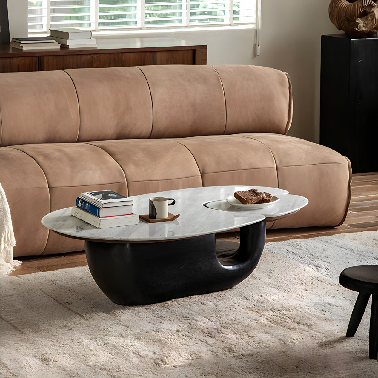 Modern Wabi-Sabi coffee table with wood and stone top, placed in a contemporary living room setting with a brown sofa.