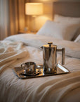 Morning Coffee Set on a bed with a lamp in the background