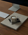 Venice Mirror Cup Set with saucer and spoon on desk, showcasing polished mirror finish and timeless elegance.