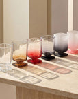 Sculpted Pedestal Glasses in several colours with light shining through