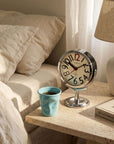 Morning Ritual Set on a bedside table: chrome Orbit clock and a blue Crushed mug