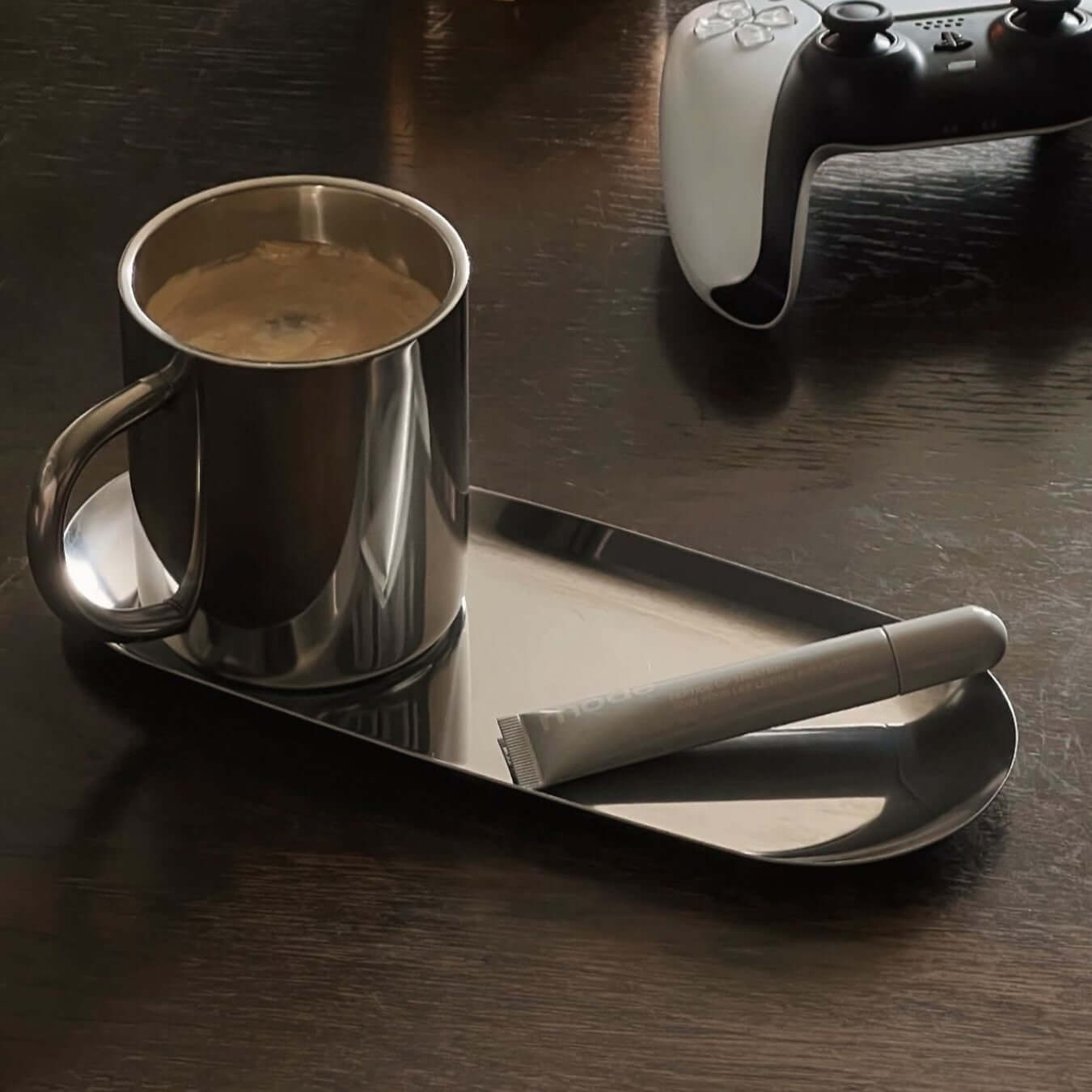 Milano Duo Set with sleek stainless steel coffee cup and tray on a table, ideal for modern settings.