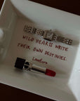 Wild Hearts ceramic tray with a red lipstick on a black surface