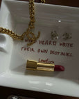 Wild Hearts ceramic tray with a gold chain necklace and red lipstick