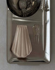 Industrial Stainless Steel Tray holding a fluted glass dish and small objects