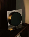 Bauhaus Aura Bedside Lamp glowing on a bedside table at night