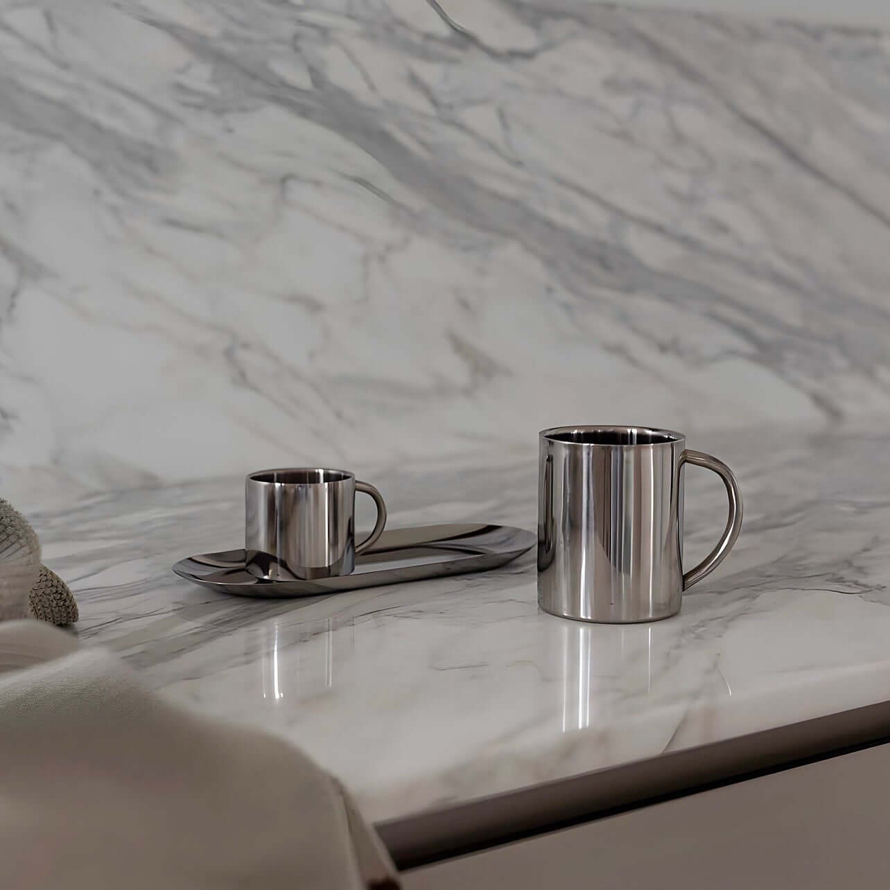 Milano Duo Set stainless steel coffee cups on marble countertop, showcasing elegant and modern design for perfect coffee moments.