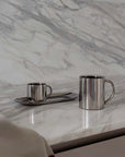 Milano Duo Set stainless steel coffee cups on marble countertop, showcasing elegant and modern design for perfect coffee moments.