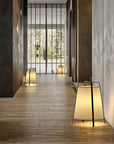 Elegant Wabi-Sabi floor lamps illuminating a modern hallway, creating a tranquil and serene atmosphere with fabric and iron design.