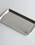 Modern stainless steel serving tray with sleek minimalist design, ideal for home use and special occasions.