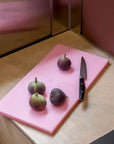 Pink Puzzle Pop Chopping Board with figs and a knife