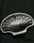 Vintage Shell-Shaped Silver Trinket Case on a black stone surface