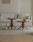 Stylish living room featuring two wooden Clown Tables with playful, block-inspired design, placed in front of a beige sofa.
