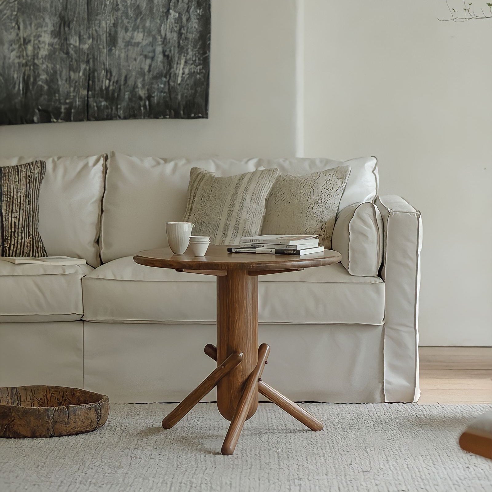 Stylish wooden Clown Table beside a cozy white sofa, adding playfulness and simplicity to the modern living room decor.