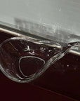Liora Hand-Blown Glass Scoop Bowl, empty, on a windowsill