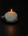 Dreamy Swing shell-shaped candle lit on its shell dish