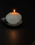 Dreamy Swing shell candle lit on a dark table