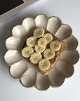 Artisan plate from the Rinka Collection with a banana-topped toast, showcasing Japanese craftsmanship and elegant design.