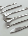 Japanese Retro Stainless Steel Cutlery Set with seven elegant brushed pieces including spoons, fork, and knife on a white background.
