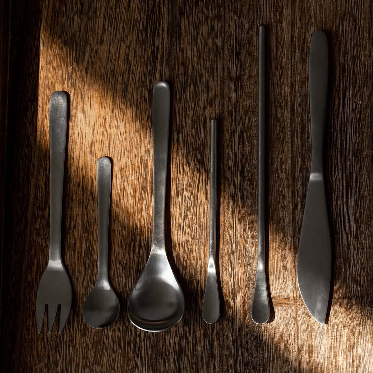 Japanese Retro Stainless Steel Cutlery Set on wooden surface, featuring six essential pieces with brushed finish.